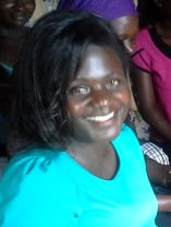 Empowered woman smiling at Pearl Global Ministries event, showcasing community support and faith-based outreach programs.