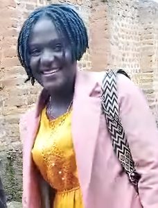 Empowered woman smiling in traditional attire, supporting community growth and spiritual development through Pearl Global Ministries.